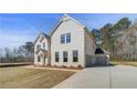 Two-story home with brick facade, attached garage, and long driveway at 200 Haverling Pass, Hampton, GA 30228