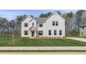 Charming two-story home with brick facade, gabled roof, and green lawn at 200 Haverling Pass, Hampton, GA 30228