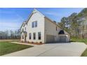 A two-story home featuring a brick facade, attached garage, and large driveway at 200 Haverling Pass, Hampton, GA 30228
