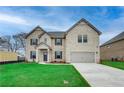 Beautiful two-story home with a well-kept lawn, attached two-car garage, and brick facade at 200 Haverling Pass, Hampton, GA 30228