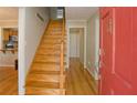 Inviting entryway with hardwood floors, staircase, and a bright red front door at 4081 Deerwood Se Pkwy, Smyrna, GA 30082