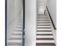 Modern staircase with wood treads, white risers, and minimalist design at 587 Red Clay Farm Ln, Suwanee, GA 30024