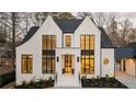 Charming exterior with white painted brick, black trim, and great curb appeal at 906 Fairfield Dr, Marietta, GA 30068