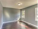 Neutral bedroom with hardwood floors, plenty of natural light, and closet for storage at 385 Arthur Sw St, Atlanta, GA 30310