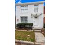 Inviting two-story home with a white brick exterior, featuring a walkway and tidy front yard at 8834 Applegate Ln, Atlanta, GA 30350