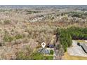 Aerial view of the property showcasing its wooded surroundings, neighborhood, and detached garage at 11637 Brown Bridge Rd, Covington, GA 30016