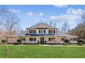 Charming two-story home with a welcoming porch, lush lawn, and beautiful architectural details at 11637 Brown Bridge Rd, Covington, GA 30016