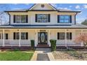 Inviting front porch with decorative columns, a charming 'Welcome' sign, and landscaped greenery at 11637 Brown Bridge Rd, Covington, GA 30016