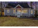 Beautiful single-story home with a welcoming front porch during the evening sunset at 1350 Bluefield Sw Dr, Atlanta, GA 30310