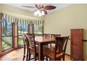 Dining room with wooden table set, bay window, curtain decor and hardwood flooring at 425 Ridgemont Dr, Lawrenceville, GA 30046