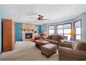 Living room with a stone fireplace, plush seating, and abundant natural light from the bay window at 425 Ridgemont Dr, Lawrenceville, GA 30046