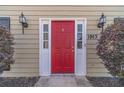 Inviting red front door with sidelights, decorative hardware, and house number 1953 at 1953 Graystone Pkwy, Grayson, GA 30017