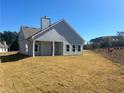 Expansive backyard featuring newly installed sod and a covered patio area at 203 Daisy Ne Ct, Cartersville, GA 30121