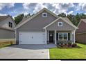 Single-Gathering home with a two-car garage, stone accents, and a manicured front lawn at 203 Daisy Ne Ct, Cartersville, GA 30121