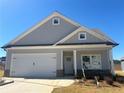 Charming single-Gathering home with a two-car garage, stone accents, and unfinished landscaping at 203 Daisy Ne Ct, Cartersville, GA 30121