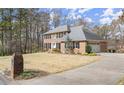 Beautiful two-story home boasting a brick facade, black shutters, and well-maintained landscaping at 5020 Puritan Dr, Sugar Hill, GA 30518