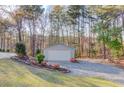 Detached two-car garage with driveway offers ample parking and storage space at 5020 Puritan Dr, Sugar Hill, GA 30518