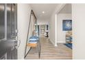 Inviting entryway with hardwood floors, modern decor, and an open view into the living space at 1217 Arnhem Dr, Hampton, GA 30228