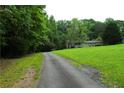 Charming home with a long driveway and a well-maintained lawn, surrounded by trees at 1537 David Lee St, Acworth, GA 30102