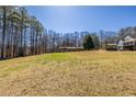 Expansive front yard view featuring a house nestled in a serene, wooded area at 1537 David Lee St, Acworth, GA 30102