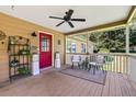 Relaxing covered porch with seating, ceiling fan, and bright red front door at 1537 David Lee St, Acworth, GA 30102