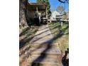 Inviting walkway leads to a covered porch and front door with a lovely landscaped yard at 1537 David Lee St, Acworth, GA 30102