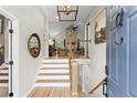 View of foyer with staircase and hardwood floors leading into the living room at 1820 N Creek Cir, Alpharetta, GA 30009