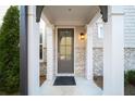 Close-up of the front door featuring stone accents and classic architectural details at 185 Bellehaven Dr, Woodstock, GA 30188