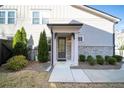 Inviting front entrance with a covered porch and manicured landscaping at 185 Bellehaven Dr, Woodstock, GA 30188