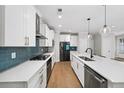 Modern kitchen featuring white cabinets, stainless steel appliances, and sleek countertops at 185 Bellehaven Dr, Woodstock, GA 30188