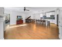 Open-concept living space with hardwood floors, piano, and kitchen view at 185 Bellehaven Dr, Woodstock, GA 30188