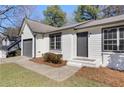 A charming home featuring a well-kept lawn and an attached single car garage at 2070 Charles Cudd Ct, Lithonia, GA 30058