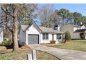 A cozy single-story house with neutral paint, neat landscaping, and a driveway at 2070 Charles Cudd Ct, Lithonia, GA 30058