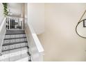 Stylish staircase with decorative stair treads, white banister, and modern wall decor at 7760 Poppy Dr, Winston, GA 30187