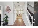 Inviting entryway showcasing hardwood floors, staircase, and views into the dining area at 1618 Blossom Dr, Atlanta, GA 30349