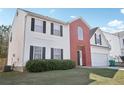 A lovely home with brick and siding, offering a neat front lawn and an attached two-car garage at 1618 Blossom Dr, Atlanta, GA 30349