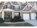 Lovely home with a brick facade, siding, and a well-manicured lawn at 301 Windswept Ct, Powder Springs, GA 30127