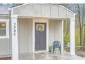 Inviting front porch with decorative wreath and a cozy seating area at 3395 Lake Valley Nw Rd, Atlanta, GA 30331