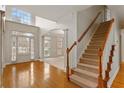 Bright foyer with hardwood floors, staircase and a view into the adjacent living spaces at 727 Vinings Estates Se Dr, Mableton, GA 30126