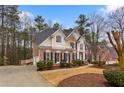 Charming two-story home with brick facade, black shutters and a meticulously maintained front yard at 727 Vinings Estates Se Dr, Mableton, GA 30126
