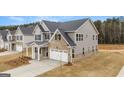 Two-story home featuring gray siding, brick accents, a manicured lawn and a two-car garage at 13224 Tolstoy, Covington, GA 30014