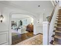 Elegant foyer with hardwood floors, arched doorways, and a staircase with carpet runner at 3814 Vermont Ne Rd, Atlanta, GA 30319