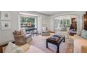 Cozy living room with large windows, neutral furnishings, and an open view to the dining area at 3814 Vermont Ne Rd, Atlanta, GA 30319