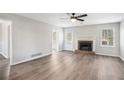 Spacious living room featuring a fireplace, modern flooring, and abundant natural light at 832 Toonigh Rd, Canton, GA 30115