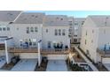 Back view of townhomes features private decks and garages, offering convenient outdoor living and parking at 361 Watson Ave, Woodstock, GA 30189