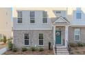 Inviting townhome exterior with classic design, featuring a stylish teal front door adorned with a floral wreath at 361 Watson Ave, Woodstock, GA 30189