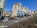 Exterior view of townhomes showcases well-maintained landscaping and brick pathways, creating an inviting curb appeal at 361 Watson Ave, Woodstock, GA 30189