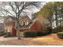 Brick home showcasing architectural details and mature trees on a spacious lot at 7155 Roswell Rd # 37, Sandy Springs, GA 30328