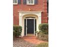 Elegant front door with decorative trim, sidelights, and brick walkway at 7155 Roswell Rd # 37, Sandy Springs, GA 30328