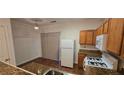 View of kitchen featuring granite countertops, ample cabinet space, and modern appliances at 911 Redwood Dr, Norcross, GA 30093